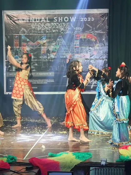 Dancers interact on stage during a vibrant, story-driven performance.