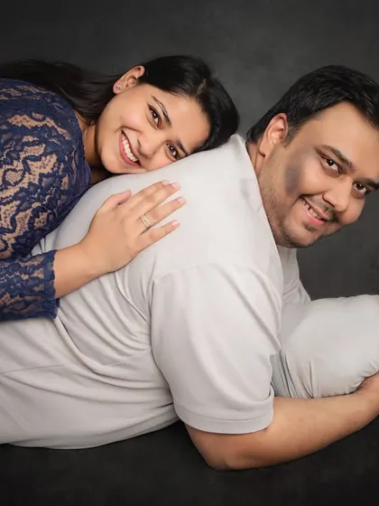A perfect family portrait from a different angle. This pose is wonderful for showing the love and security surrounding your new baby, with mom and dad smiling close by.