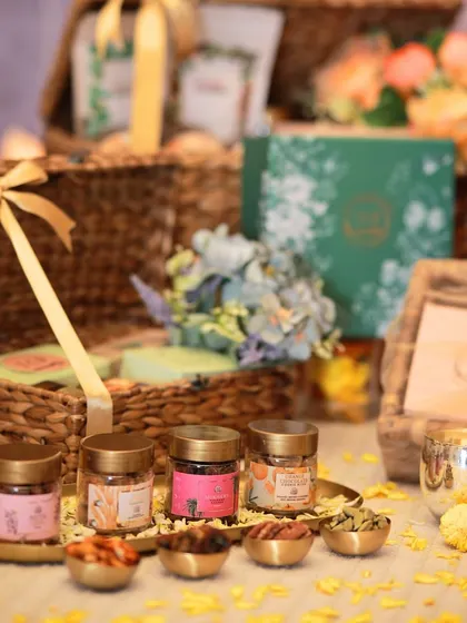This is our luxurious Kalpataru trunk hamper, overflowing with goodies. It includes two types of granola, chocolate cookies, cookie bites, mukhwas, flavored nuts, a diya, and more in a reusable eco-friendly trunk.
