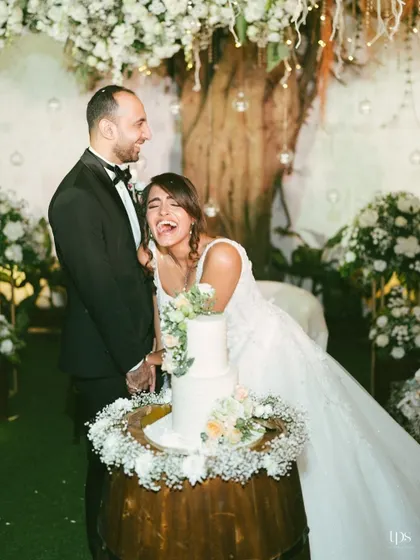 A moment of pure, uninhibited laughter during the cake cutting. This candid shot perfectly captures the fun and joy of the celebration.