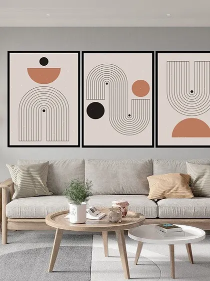 A beautiful set of three framed prints featuring abstract geometric compositions. The clean lines, arches, and circles in a neutral palette create a modern and harmonious display for any contemporary home.