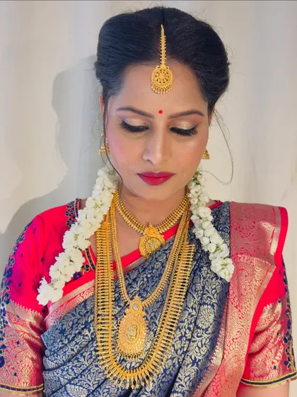 My bride Gulista, dolled up for her wedding. This is a beautiful example of a South Indian bridal look with a focus on classic gold jewellery and a bright, festive color palette.