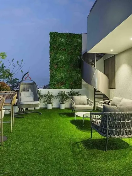 This terrace makeover features high-quality artificial turf for a low-maintenance green space, complemented by a vertical garden wall and modern outdoor furniture, perfect for urban living.