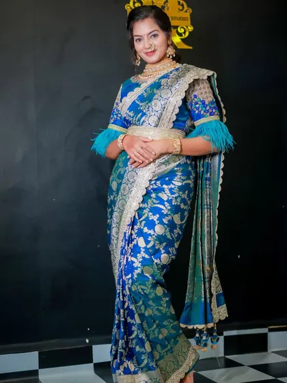 The bride looks confident and happy in her modern-traditional ensemble. The drape is secure and flattering, perfect for a long day of festivities.