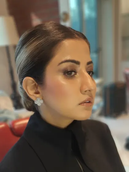 This angle highlights the smooth, flawless finish of the foundation and the elegant lines of the low bun, demonstrating our attention to detail.