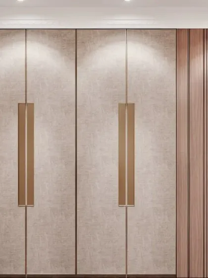 This wardrobe features a beautiful combination of textured, fabric-like laminate and wood-grain panels. The oversized metallic handles add a touch of modern sophistication to the design.
