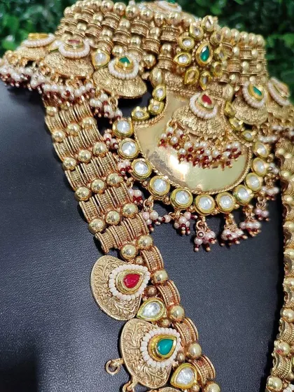 A closer view of the intricate motifs on this temple jewellery set, showing the craftsmanship in the choker and the pendant of the long necklace.