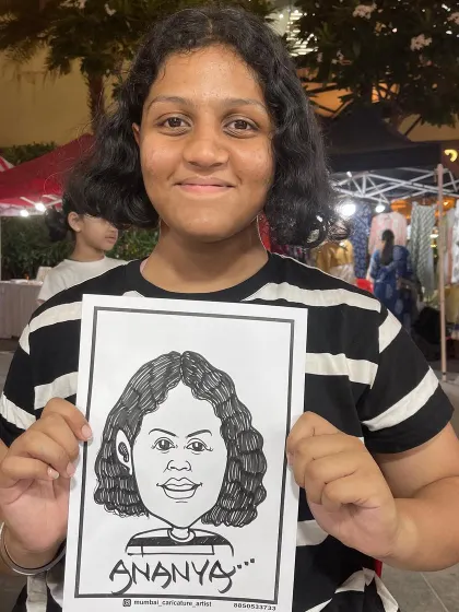 A young guest proudly displays her caricature at an event in R-City Mall, Ghatkopar.