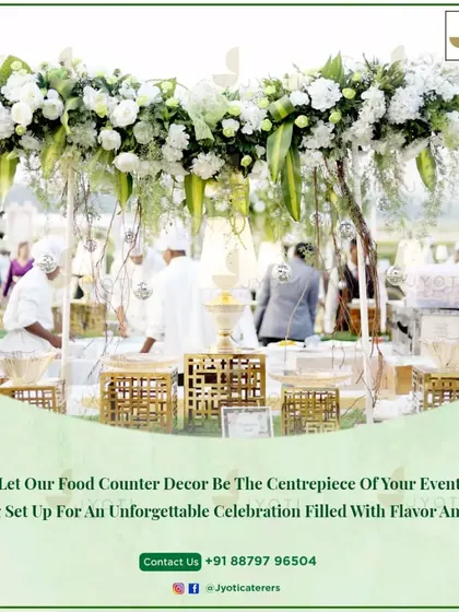 A stunning floral canopy hangs over this golden buffet counter, acting as a beautiful centerpiece for an outdoor garden event.
