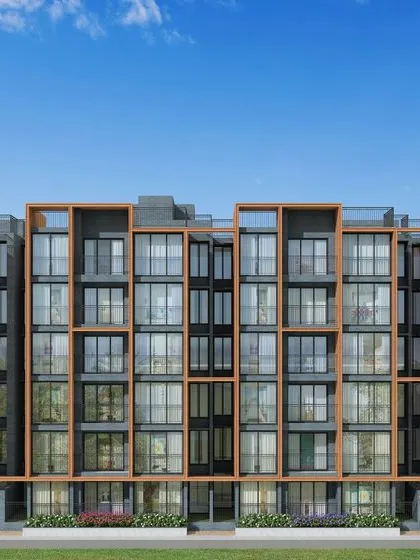 The facade of Casagrand SouthBrooke features a rhythmic pattern of terracotta-colored frames and glass, creating a contemporary and visually engaging exterior.