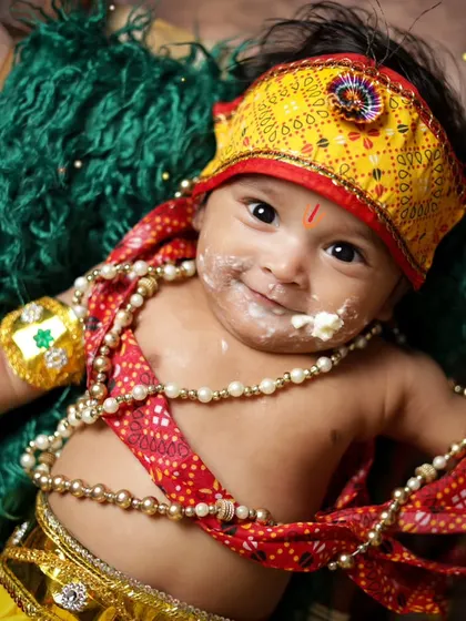 A close-up of a baby Krishna with a little makhan on his face. It's the small, playful details that make these shoots so special.
