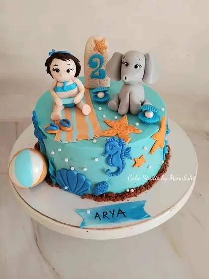 A sweet sea themed cake for a 2nd birthday. This design features a little girl, her favorite elephant, and lots of cute sea creatures like seahorses and starfish.