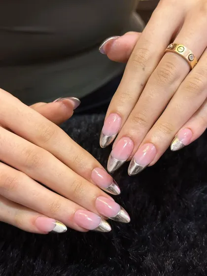 Taking the classic French manicure to the next level. This look features a clean, natural pink base on long, almond-shaped nails, but with a futuristic twist: a flawless, mirror-like silver chrome tip. It's sophisticated with a modern edge.