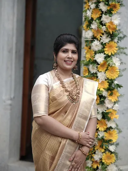 A happy portrait of Shilpa, her smile as bright as her golden saree.