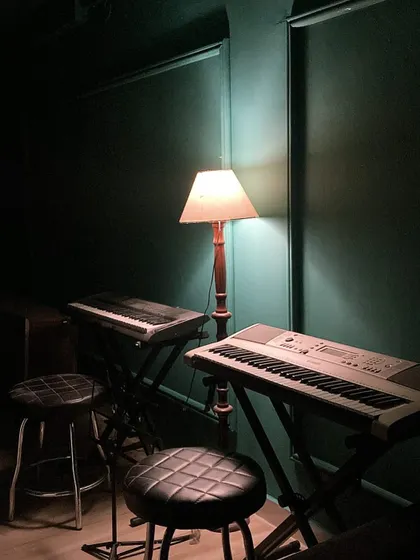 The quiet ambiance of our studio, with keyboards ready for the next lesson. We provide a calm and focused environment for learning.