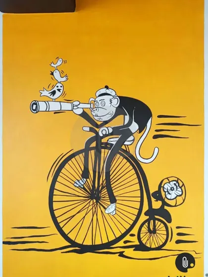 A whimsical selfie point in Dehradun featuring a monkey in a suit riding a penny-farthing bicycle. This kind of quirky, custom character art adds a unique and memorable touch to any location.