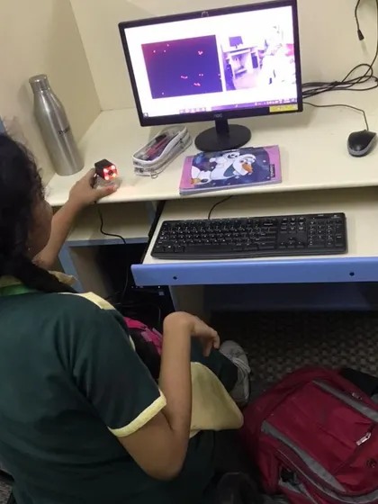 A student works on an AI project, using a camera and computer to run a program that involves image recognition.