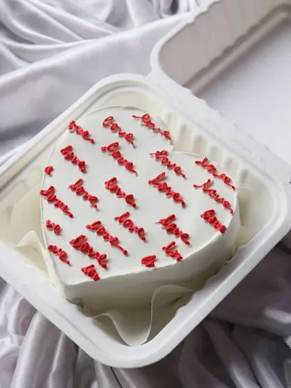 A heart-shaped bento cake covered in the word 'love'. The perfect romantic gesture.