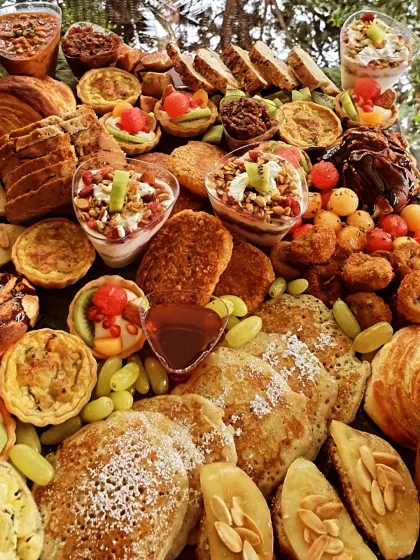 Pancakes, pastries and handmade granola parfait cups fill our breakfast platter, with fruit and little savoury bites alongside.