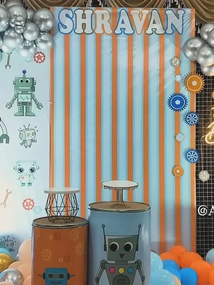 For the little one who loves robots, we designed this fun and futuristic robo-themed party. The backdrop features robot graphics, gears, and a cool color palette of orange, blue, and silver.