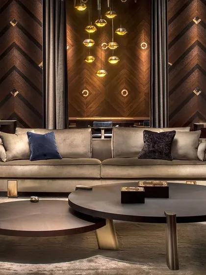 Defined by simple geometric lines, the striking elegance of these two nested coffee tables is in the rich details. A stately round oak veneer top sits atop three brass slanted rectangular feet.