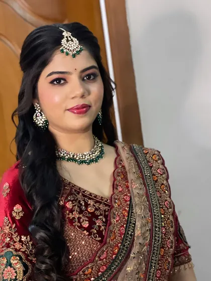 A modern reception look with a velvet lehenga. The makeup is glamorous with defined eyes and a bold lip.