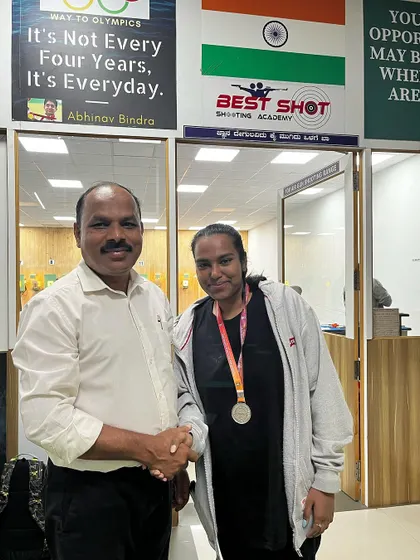 Hrudya with her silver medal, being congratulated by me at the academy.