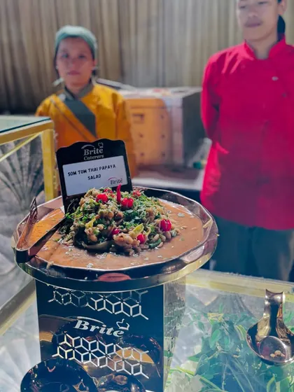 The Som Tom Thai Papaya Salad presented on an ornate stand, ready for guests to enjoy.