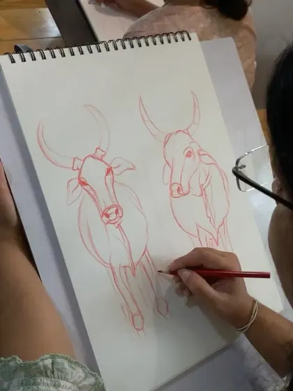 This image captures a student deeply focused on their freehand drawing. Repetitive practice like this is essential for building the muscle memory required for advanced sketching.