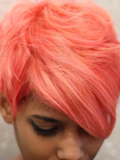 We love mixing custom colors to create unique shades. This coral-pink pixie is a perfect example of our creative color work, a one-of-a-kind shade for a one-of-a-kind client.