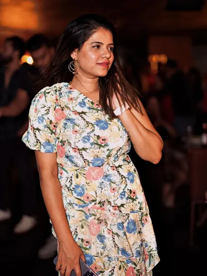 A guest in a floral dress, enjoying the music and the Saturday night atmosphere.