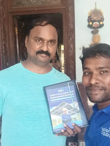 Our team member with a customer holding our solar guide. We are committed to providing the best service.