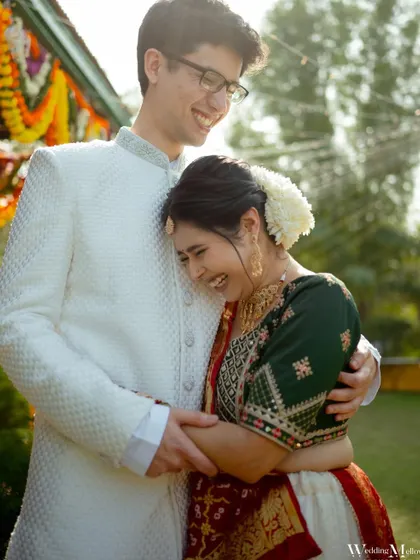 A moment of pure, uninhibited laughter between the couple. This candid shot perfectly captures their easy-going chemistry and the joy of their celebration.