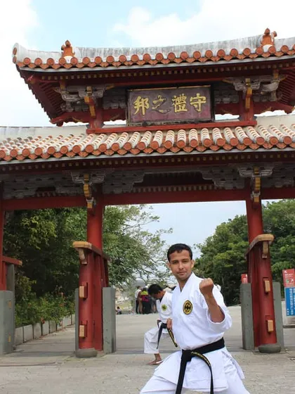 Practicing a fighting stance in front of the Shureimon gate at Shuri Castle in Okinawa. This location is deeply connected to the history of Okinawan martial arts, and it is an honor to practice there.