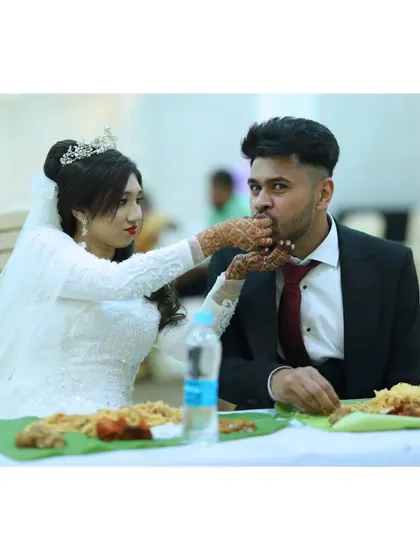 A beautiful moment from a Muslim wedding, where the bride and groom share a meal. We cater to all communities and all types of celebrations.