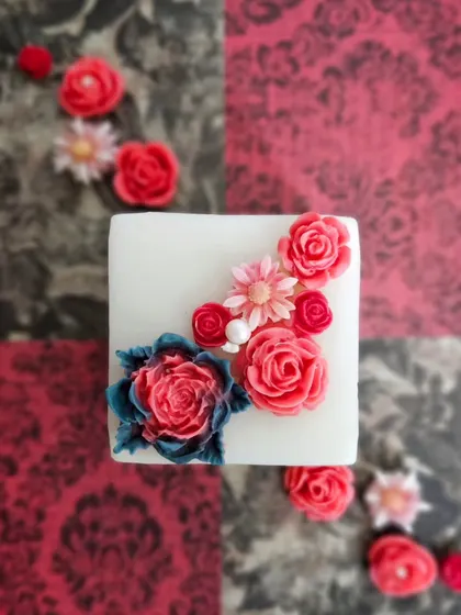 An overhead view of my Regal Pillar Candle, showcasing the bouquet of wax flowers on top. This is a true statement piece, available in Rose Blossom or Fresh Lavender fragrances.