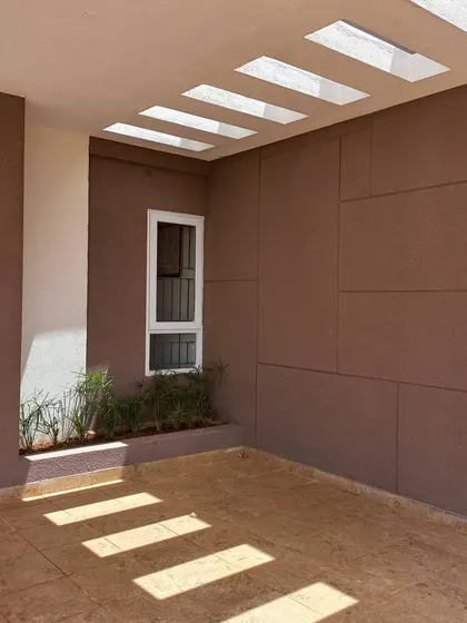 A direct view of the light-filled entryway, showcasing the clean lines of the skylights and the warm tones of the wall panels.