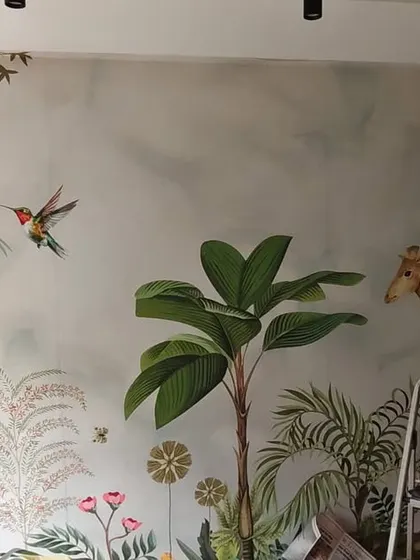 A jungle-themed wallpaper installation in progress in Bandra. This shot shows the scale of the mural and the careful work required to align each panel.