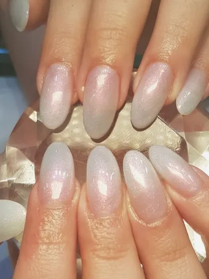 Simple but elegant. This beautiful manicure features a sheer, shimmery base with a soft glitter gradient for a delicate and sophisticated sparkle.