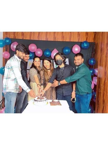 Our male students joining in the cake-cutting ceremony. At Meribindiya, everyone is part of the family.