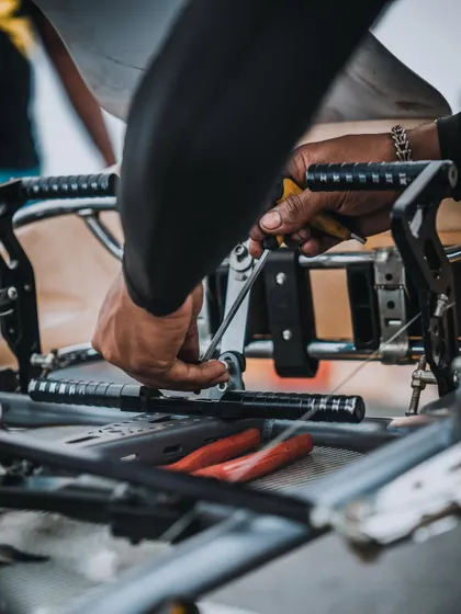 Every detail matters. A mechanic makes fine adjustments to the pedal assembly, ensuring the driver has perfect control over throttle and braking inputs.