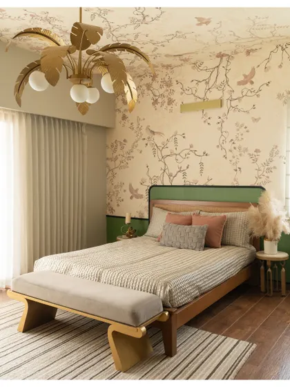 This master bedroom is a perfect example of Organic Modern design. A beautiful tropical wallpaper extends to the ceiling, complemented by a unique palm-leaf chandelier.