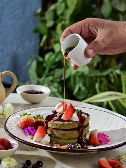 My Millet Pancakes are a healthy and delicious breakfast option, served with fresh berries, compote, and maple syrup.