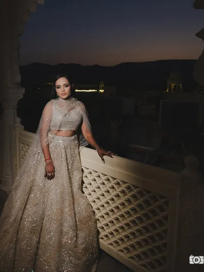 A magical sangeet night look. The dramatic smokey eye and glowing skin stand out beautifully against the evening sky, making my bride Shreya look absolutely ethereal in her shimmering lehenga.