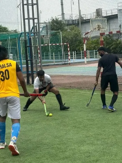 Three players converge on the ball during a competitive drill. This photo captures the fast-paced nature of our training, where players learn to react quickly and work together.