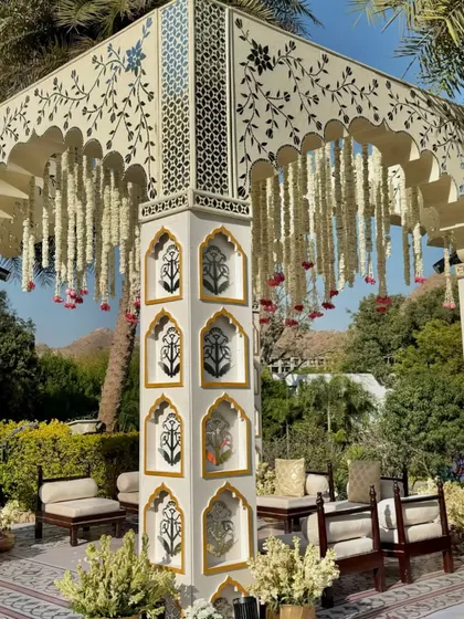 A closer look at the intricate details, from the hand-painted motifs on the pillars to the delicate canopy of hanging tuberoses.