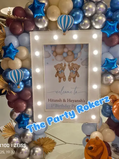 A personalized welcome sign for a twins' first birthday with a cute "two bears" theme, framed by a beautiful balloon arrangement.