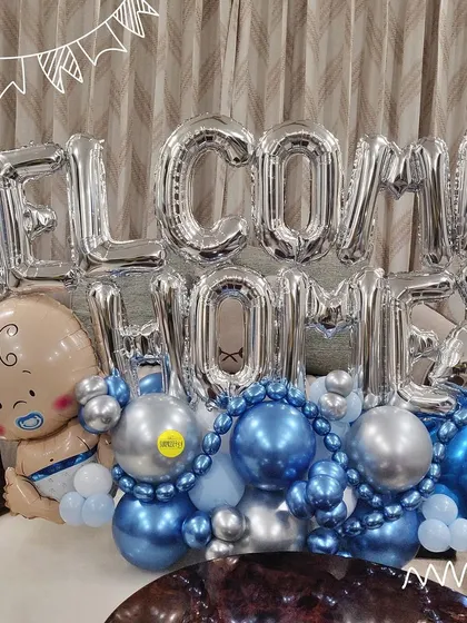 A "Welcome Home" bouquet perfect for a baby boy. The silver foil letters are paired with blue and silver chrome balloons and a cute baby boy foil balloon.