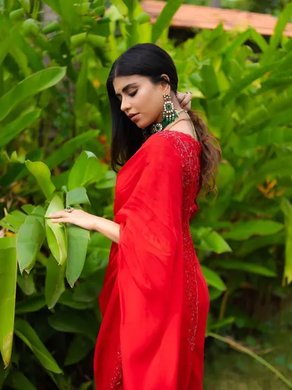 A candid-style shot where the bride interacts with the surrounding nature. It feels soft, romantic, and unstaged.