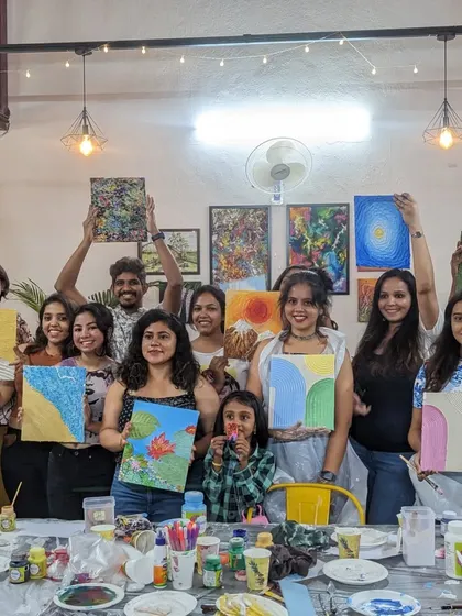 A group photo of our texture painting workshop participants, all proudly displaying their unique and tactile creations.